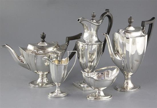 An Edwardian five piece silver vase shaped pedestal tea and coffee service and a plated tray, gross 63.5 oz.